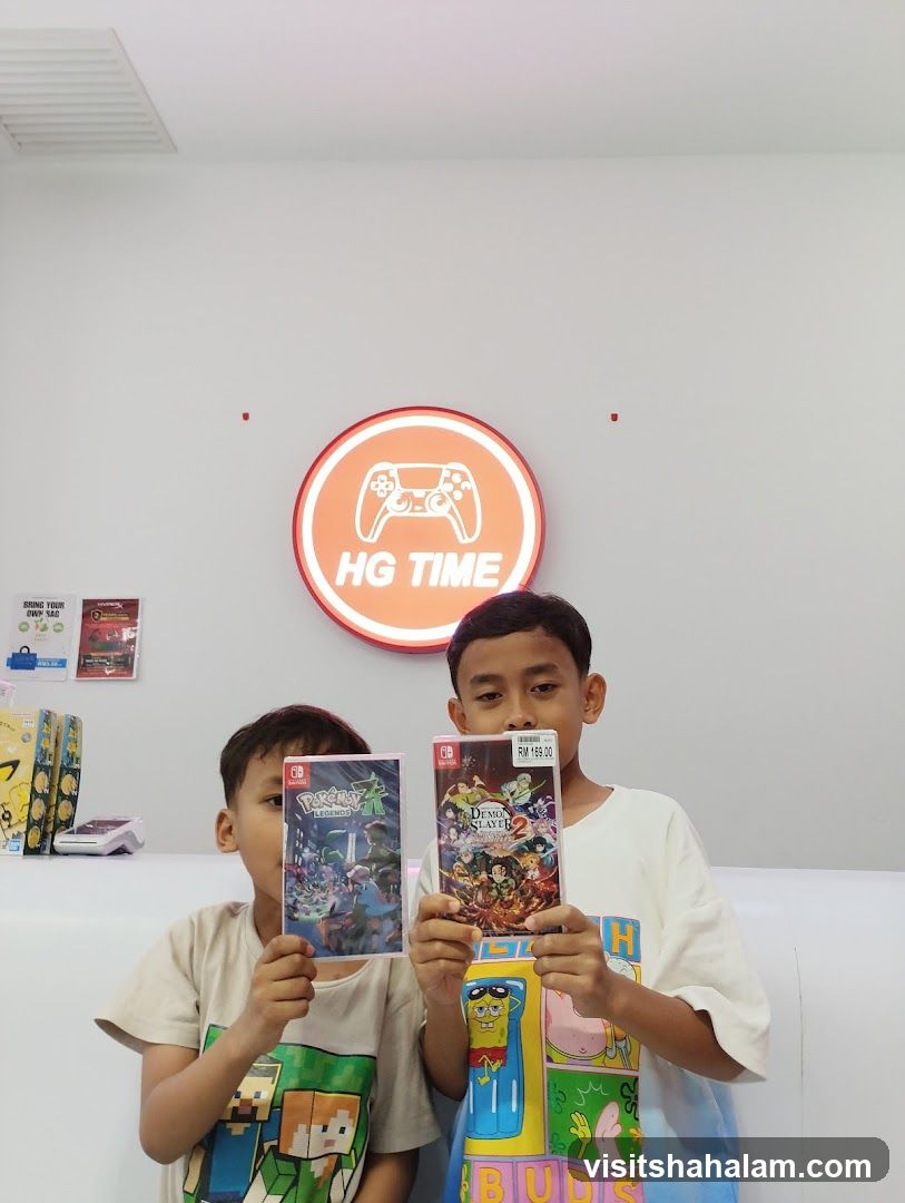 Two boys holding video games