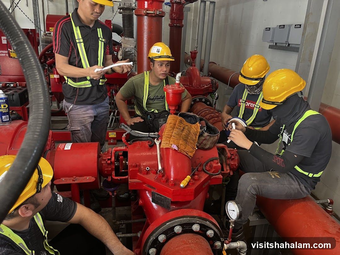 Workers inspecting pump equipment