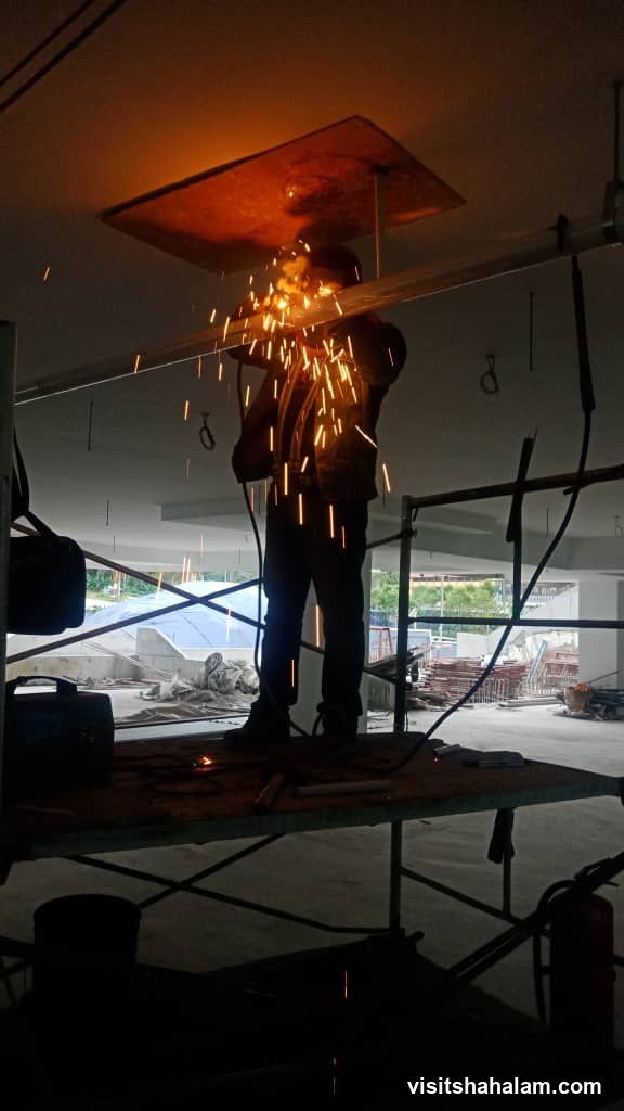Welder working on scaffolding