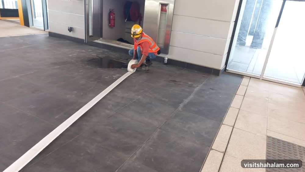 Worker laying down tape