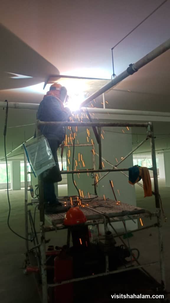 Welder working on scaffolding