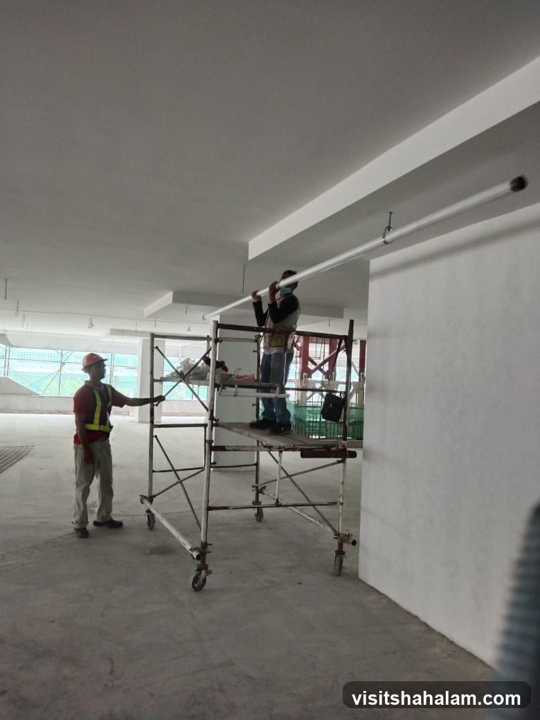 Construction workers installing lights