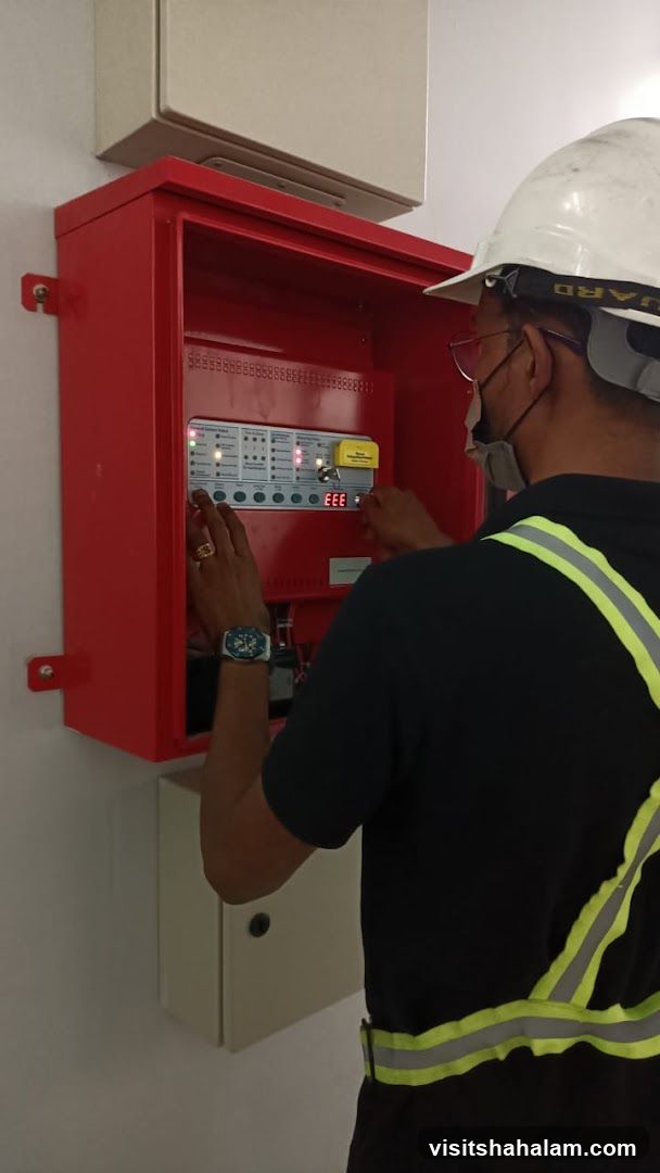 Technician working on fire alarm panel