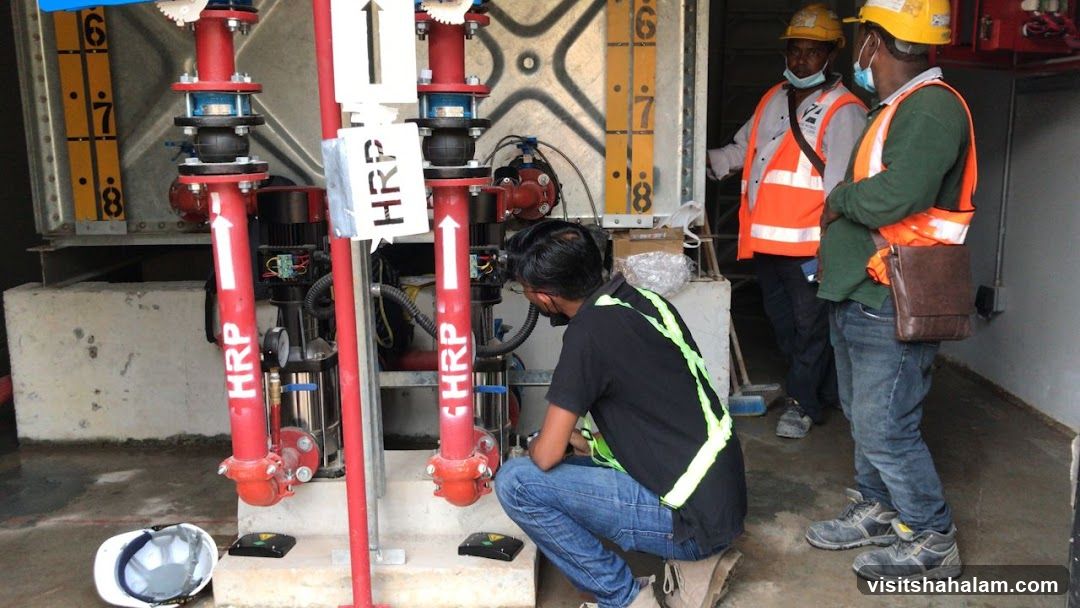 Workers inspecting pump system