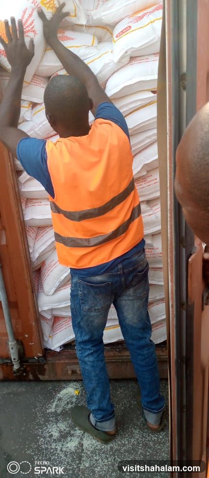 Worker loading bags of rice