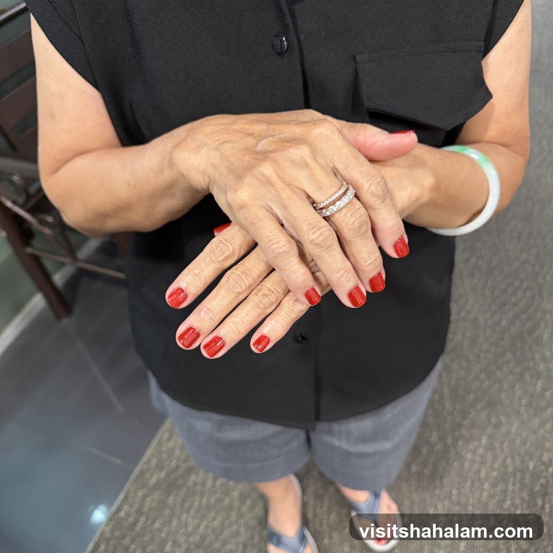 Woman's Hands with Red Nail Polish and Rings