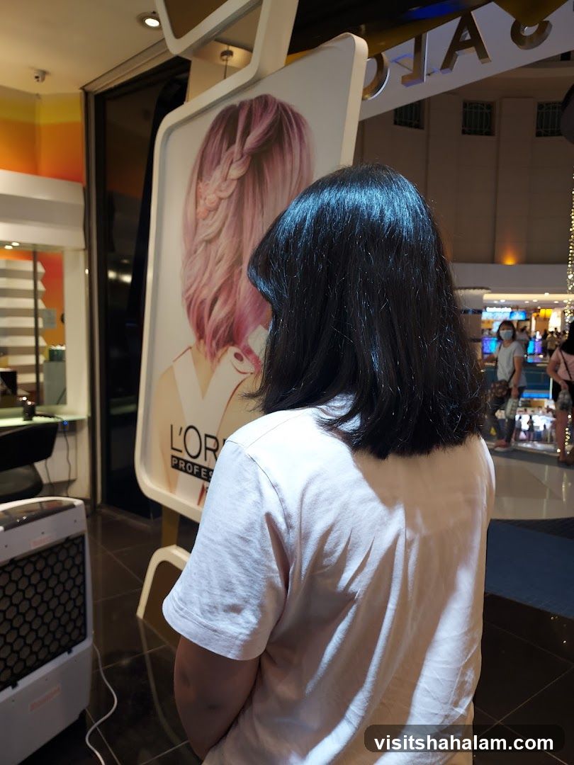 Woman looking at L'Oréal hair advertisement
