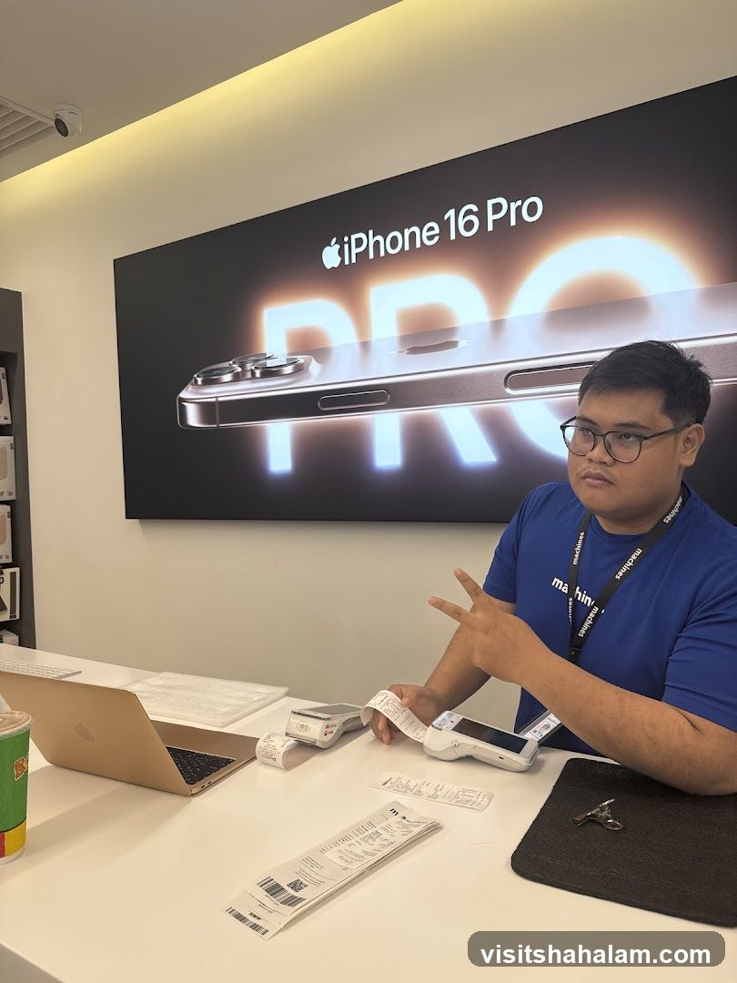 Man behind a counter with iPhone 16 Pro advertisement