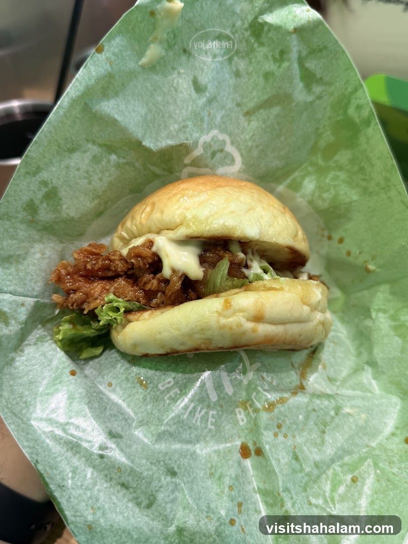 Burger in green wrapper