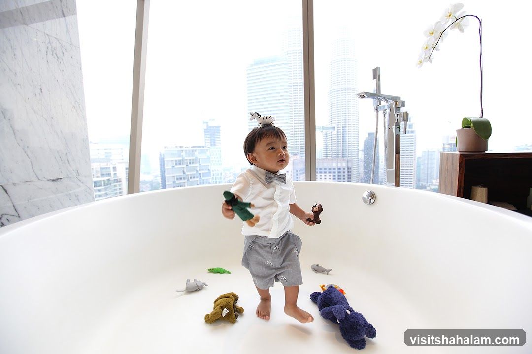 Child playing in a bathtub with toys