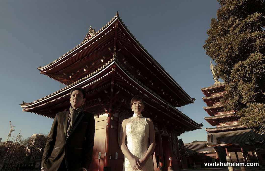 Couple Posing in Front of Traditional Japanese Architecture
