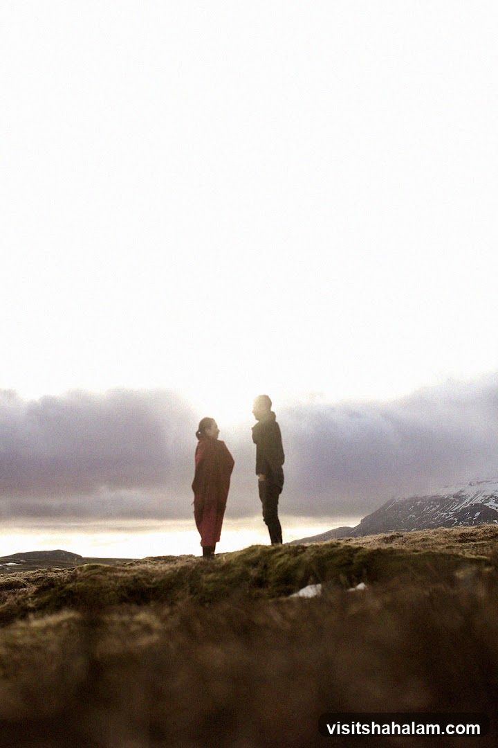 Two people standing on a hill