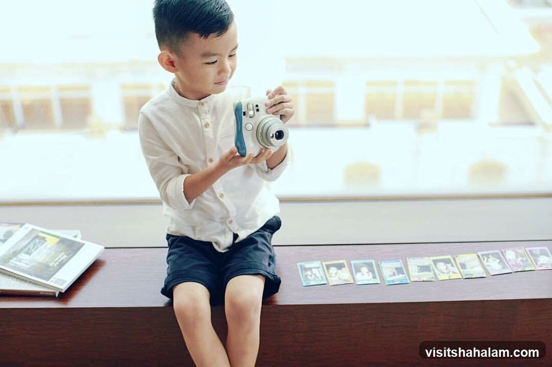 Boy with Instant Camera and Photos