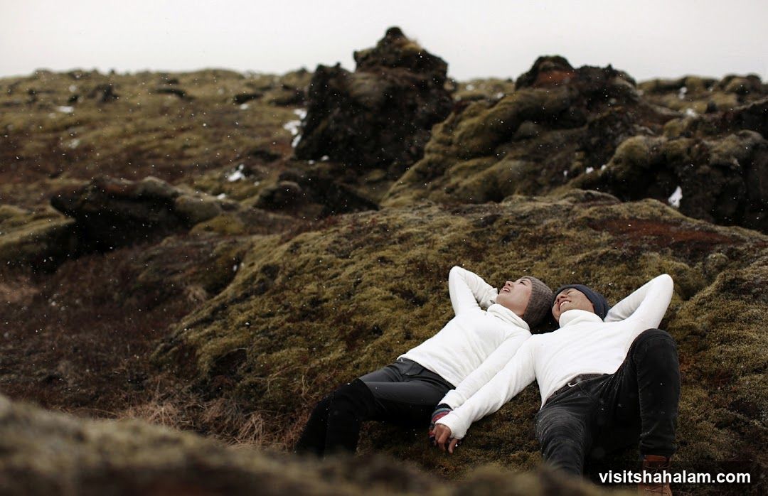 Couple lying on mossy ground