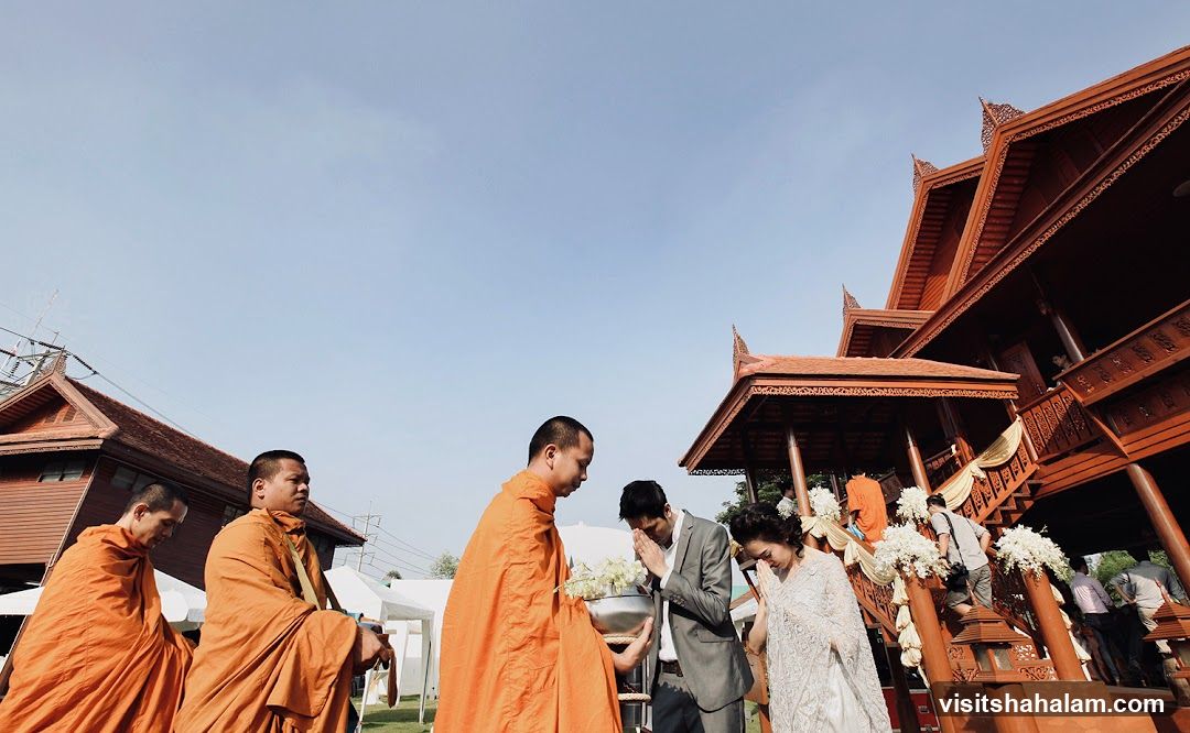 Monks and a couple at a traditional ceremony