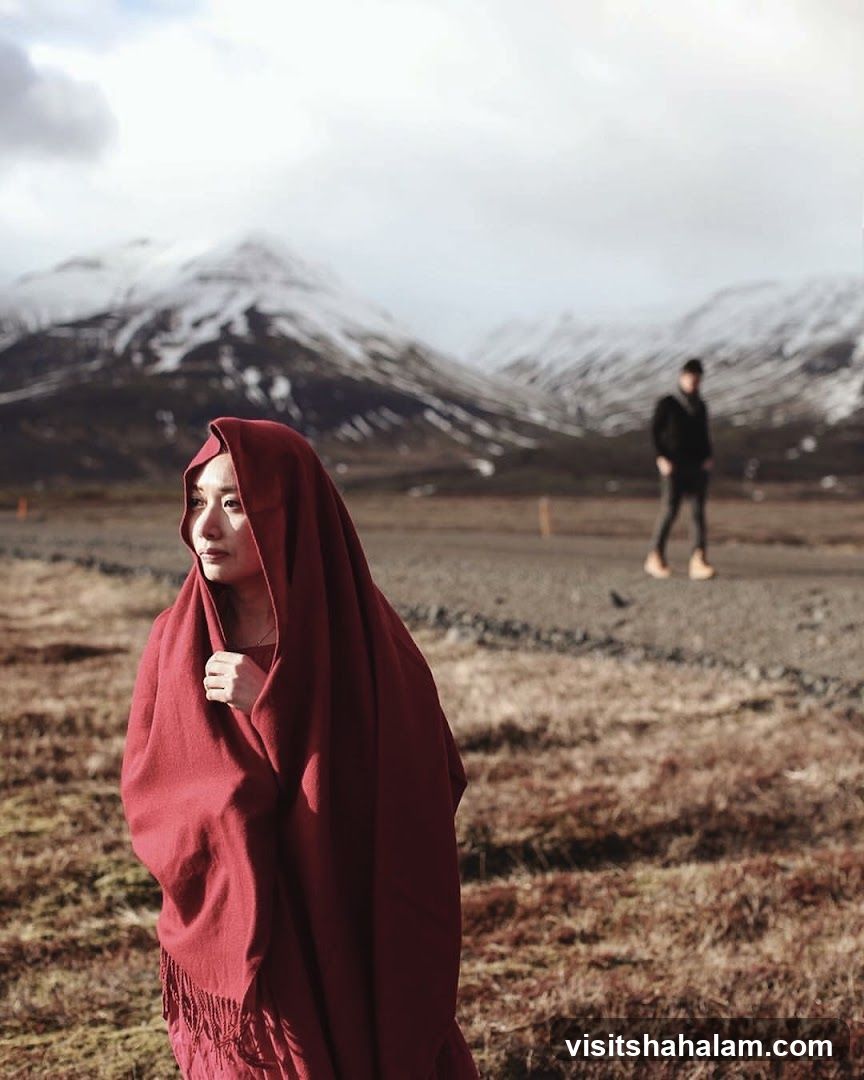 Woman in Red Shawl with Mountains in Background