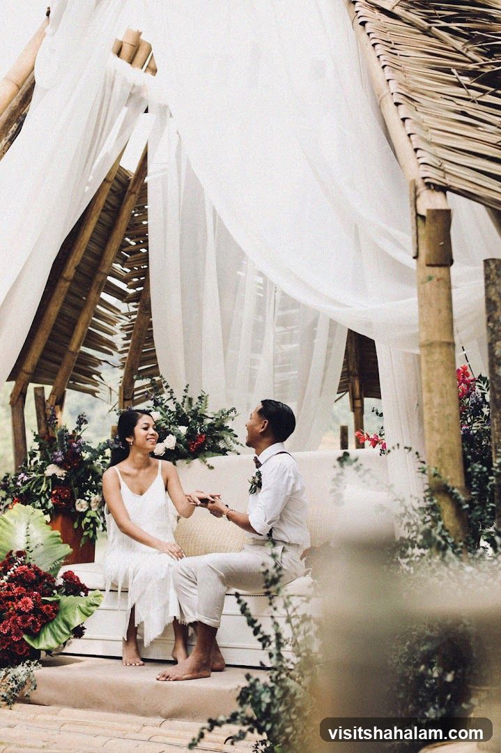 Couple sitting on a couch under a bamboo structure