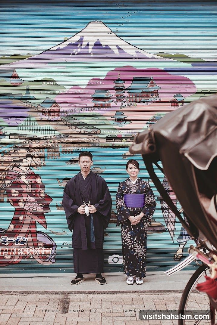 Couple Posing in Front of Japanese Mural