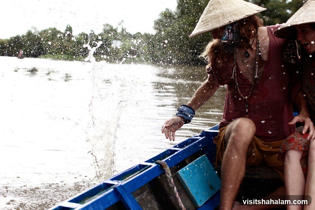 People in a boat splashing water