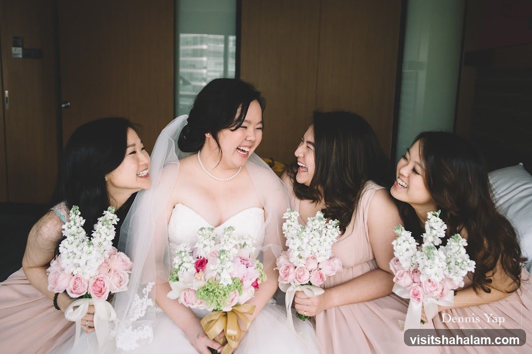 Bride and bridesmaids laughing