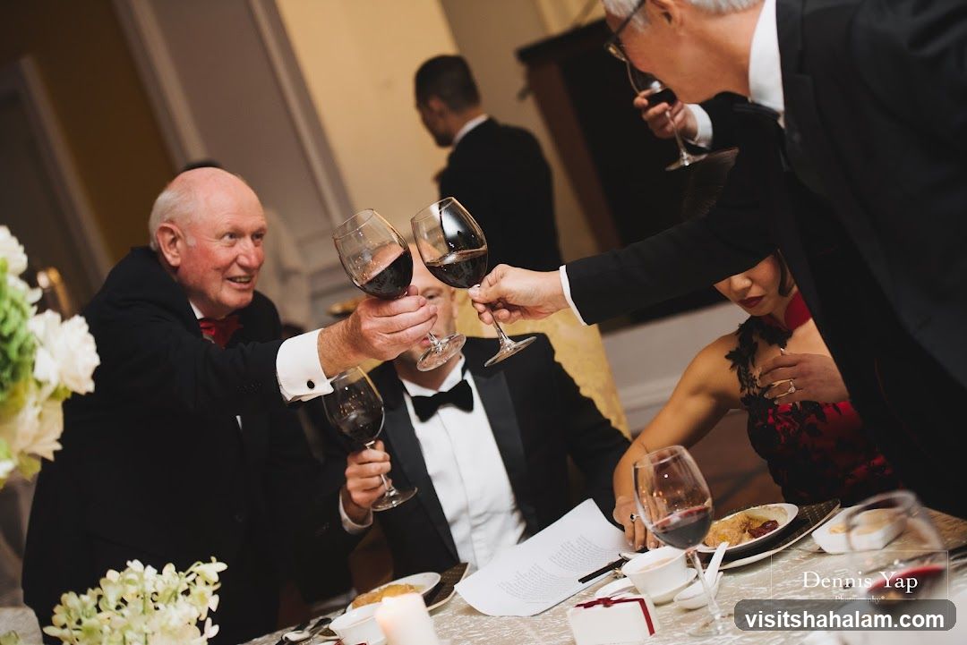 People toasting with wine at a formal event