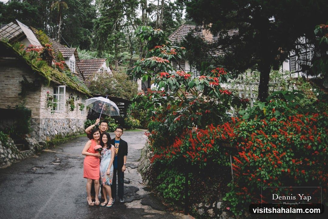 Family Posing Under Umbrella