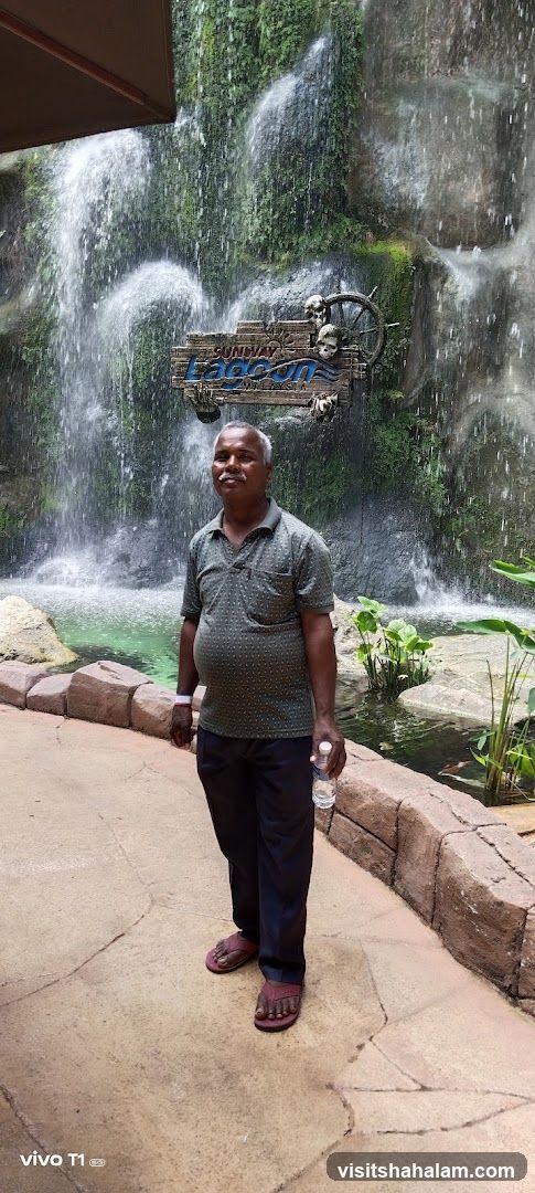 Man in front of a waterfall