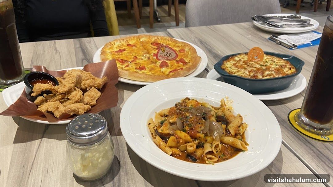 Table with Pizza, Pasta, and Fried Chicken