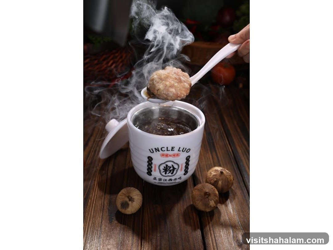 Steaming Bowl of Soup with Meatball