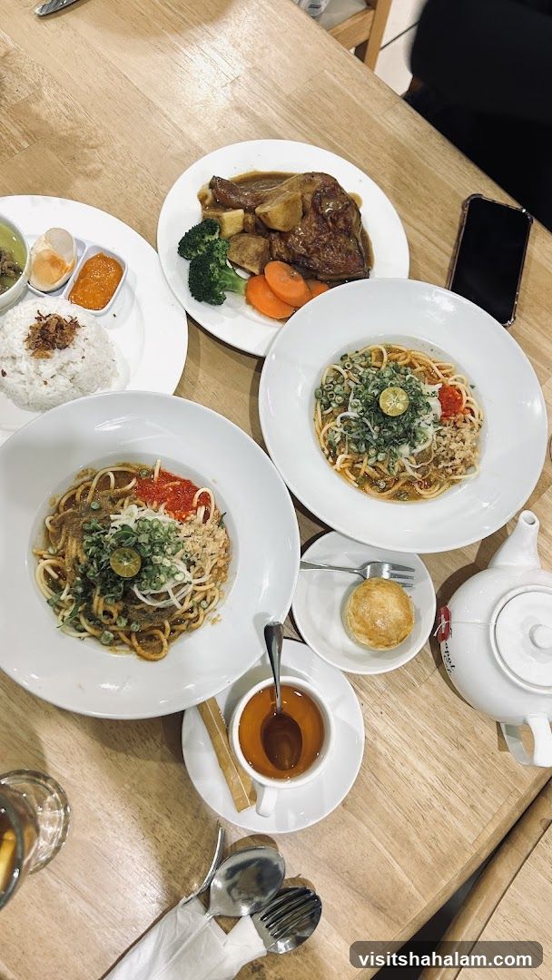 Table with various dishes and tea