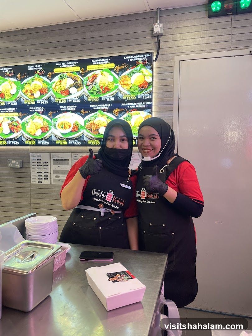 Two women in aprons in front of a menu