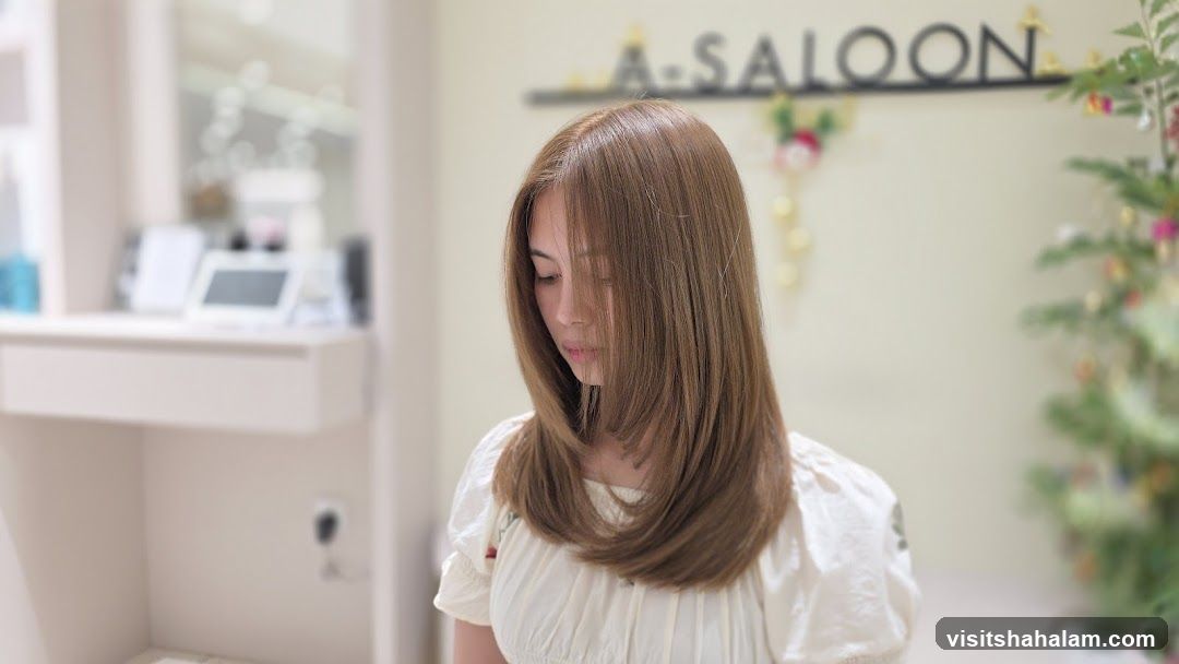 Woman with long brown hair in a salon