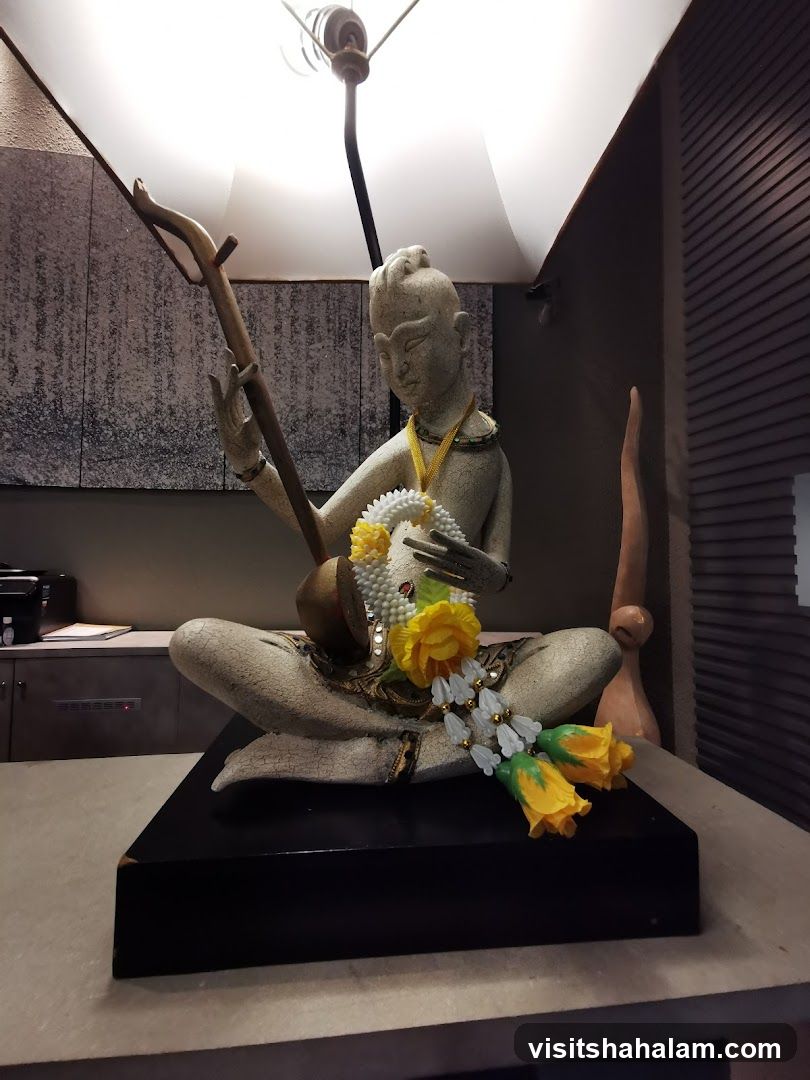 Statue with Musical Instrument and Garland