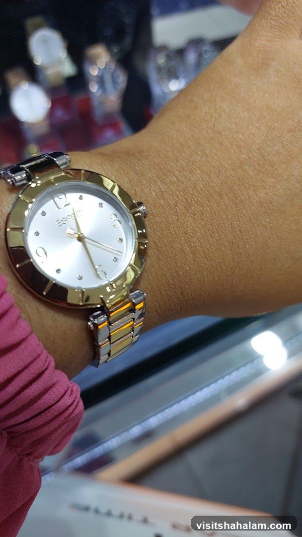 Woman wearing a gold and silver watch