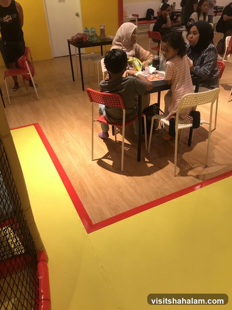 People sitting at tables in a play area