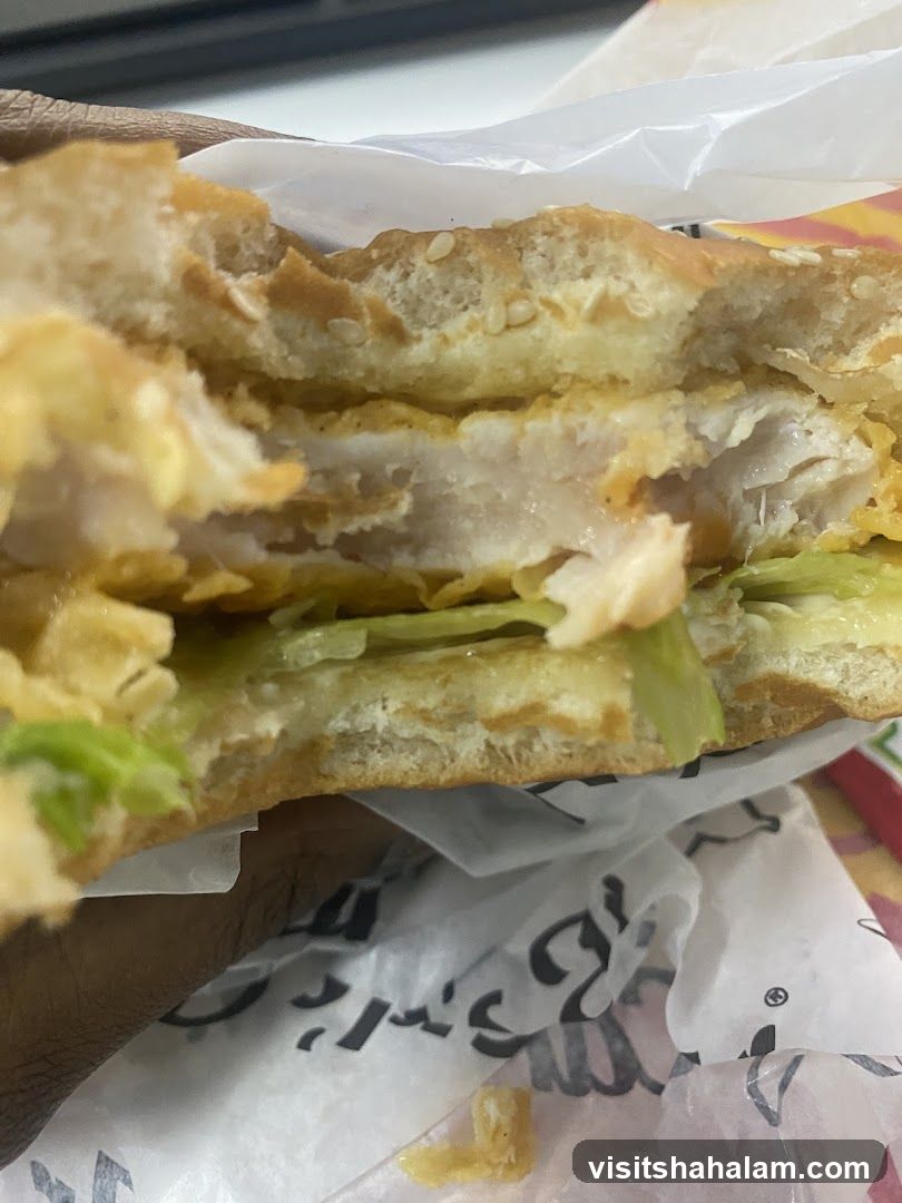 Close-up of a partially eaten chicken sandwich