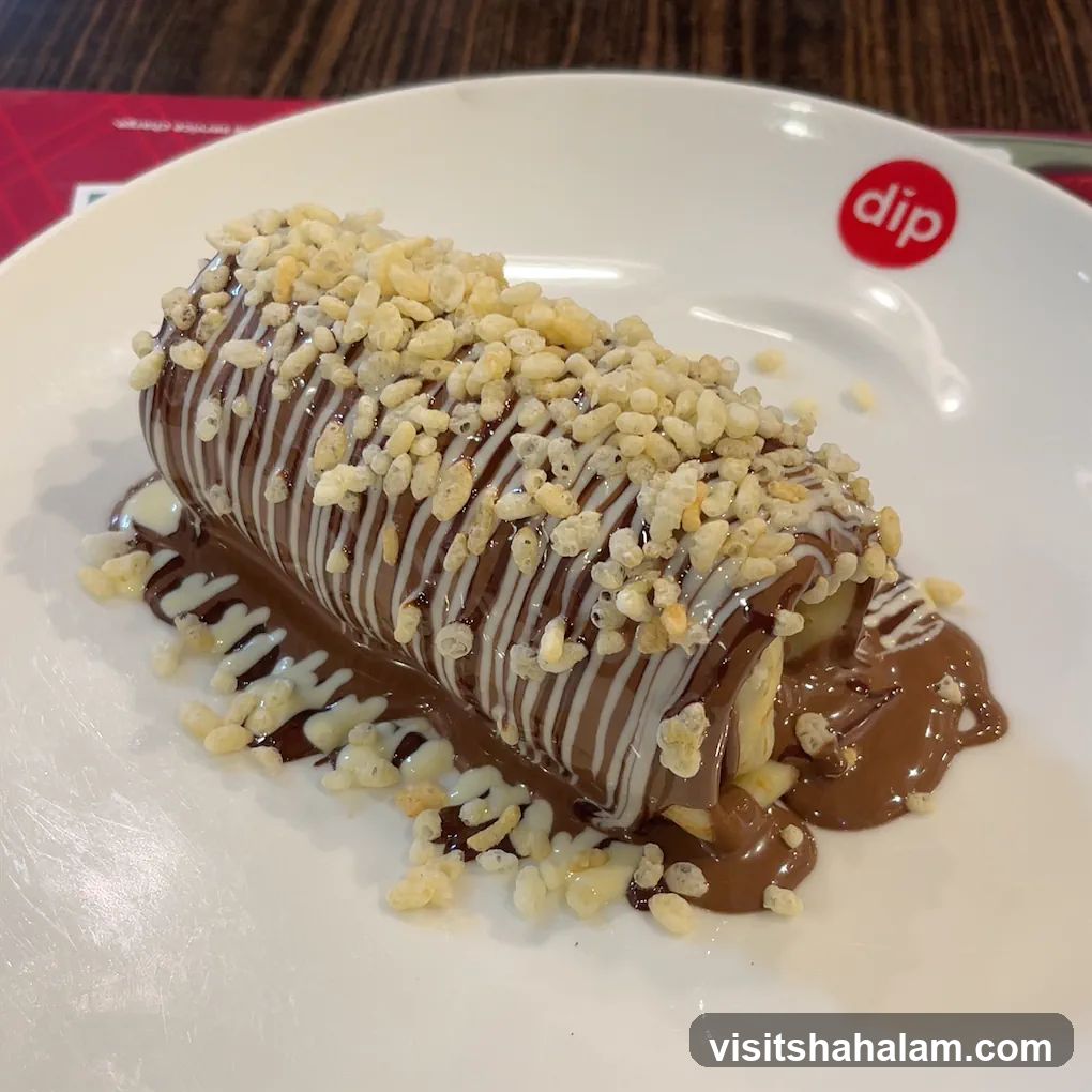 Chocolate-covered dessert with crispy rice topping