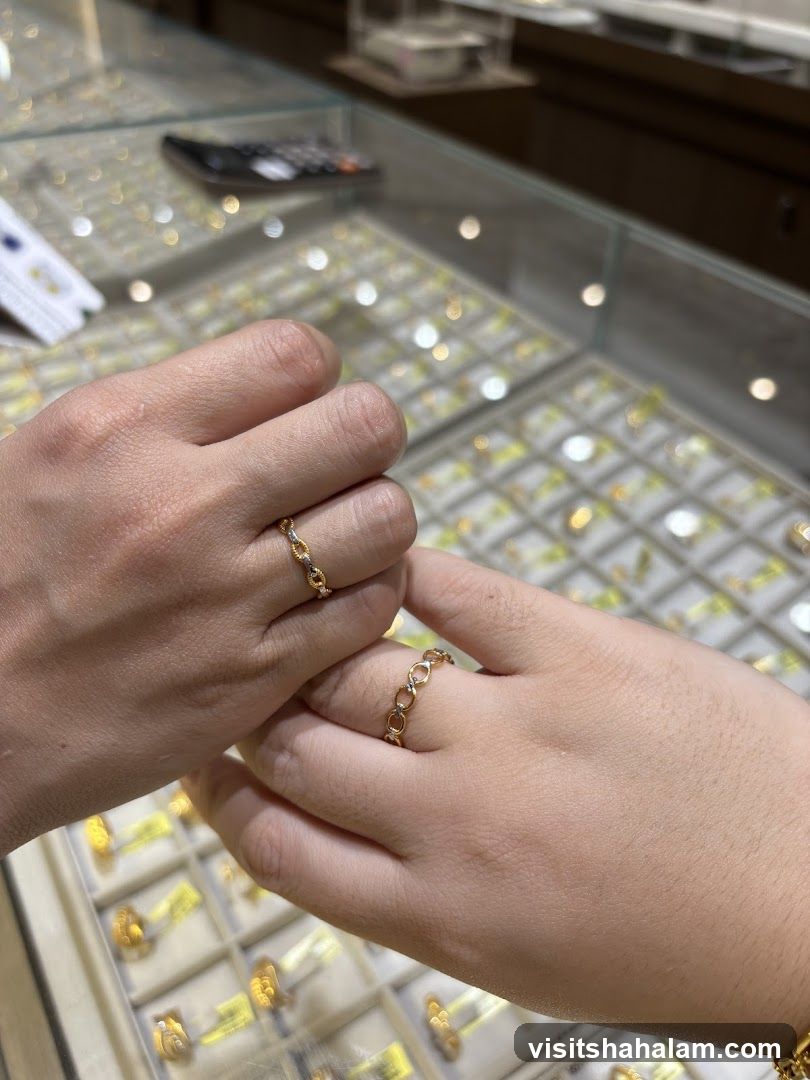 Two hands wearing rings in a jewelry store