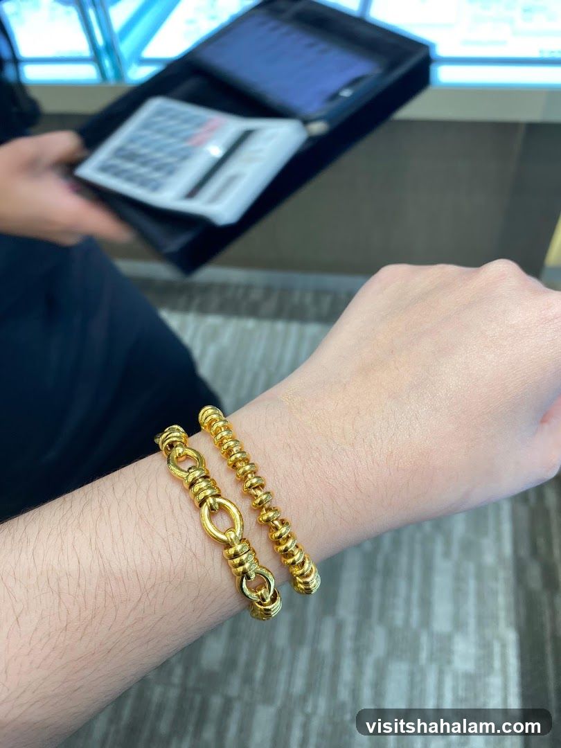 Two gold bracelets on a wrist