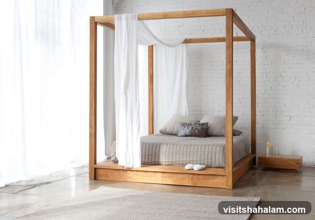 Four-poster bed with white curtains