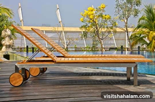 Wooden lounge chairs by a pool