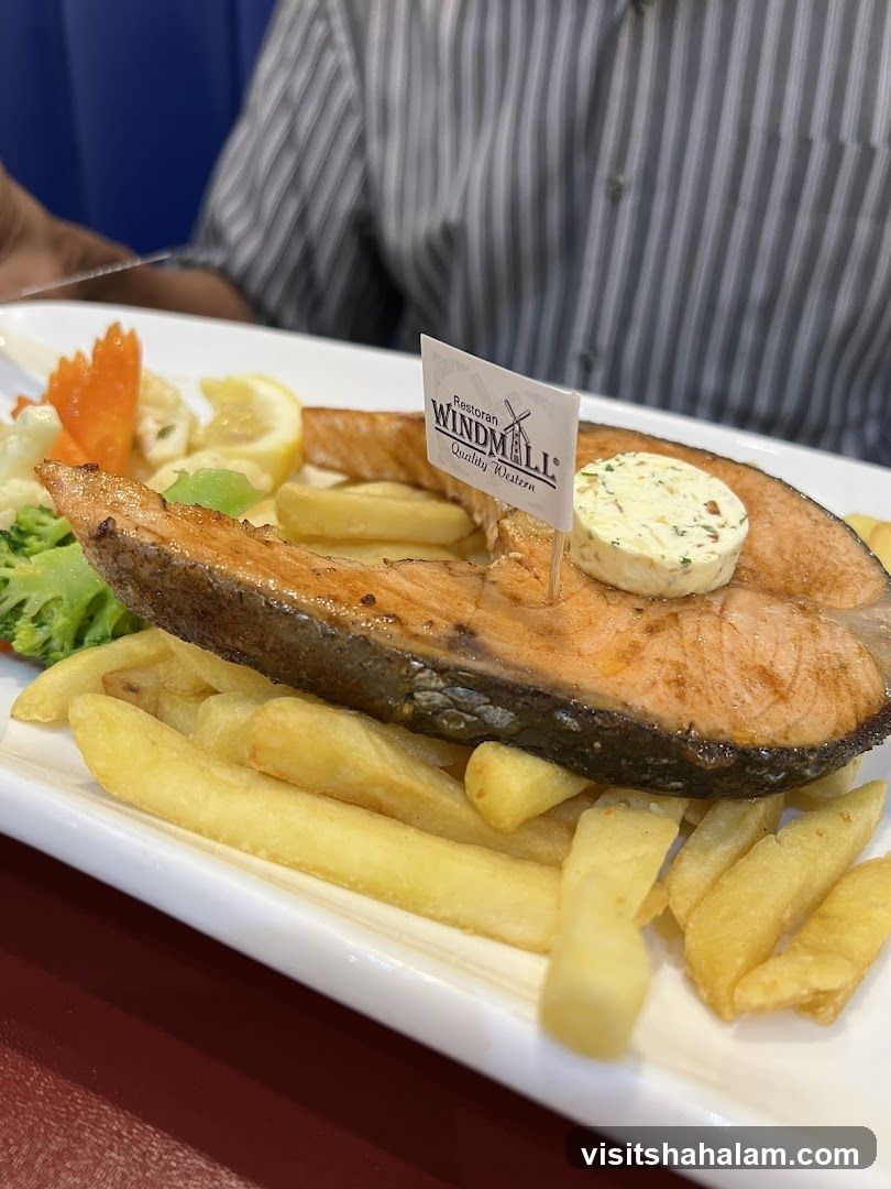 Salmon steak with fries and vegetables