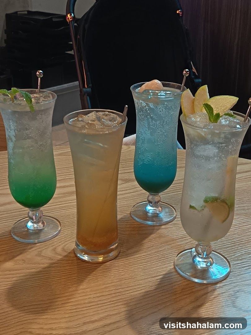 Four Colorful Drinks on a Wooden Table