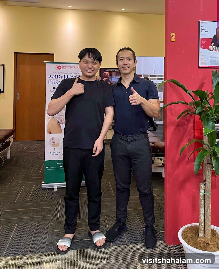 Two men giving thumbs up in a clinic