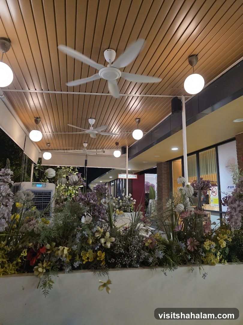 Outdoor seating area with decorative plants and ceiling fans