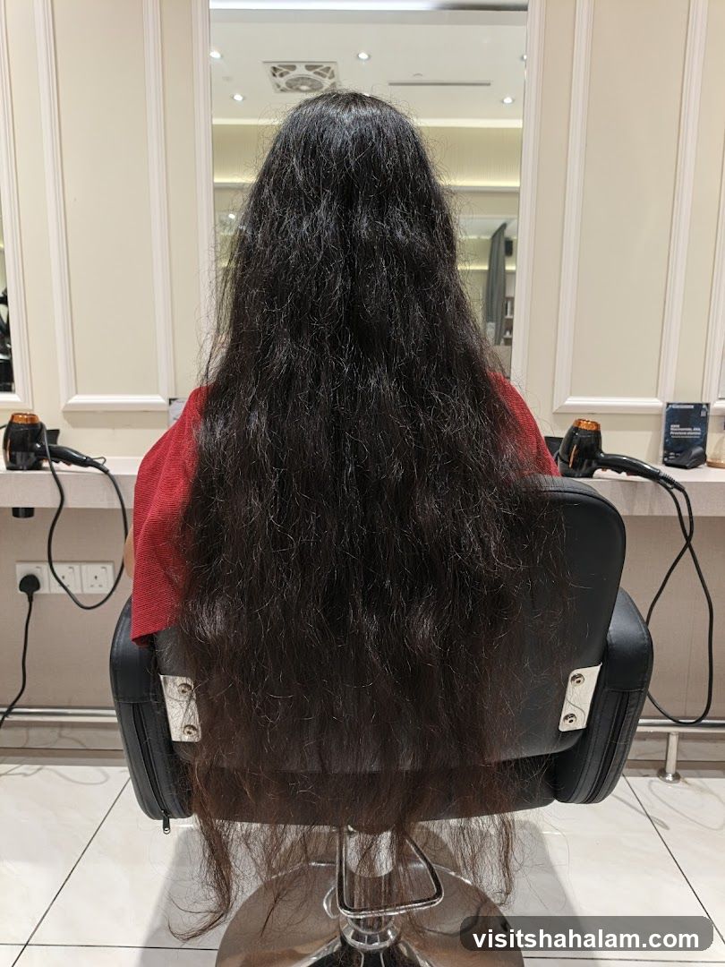 Woman with long dark hair sitting in a salon chair